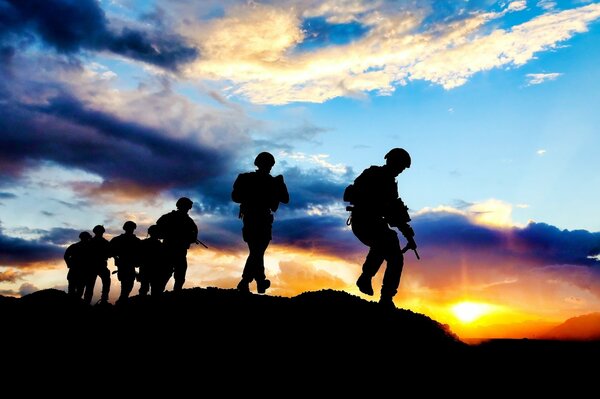 Silhouettes of soldiers at sunset