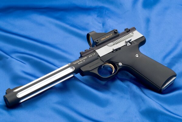 A pistol with an optical sight on a blue background