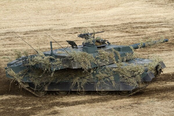 A camouflaged military tank on the field