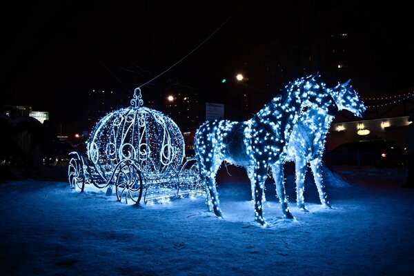 Horses and carriage made of garlands in the snow