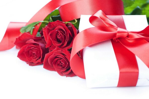 A gift with a red ribbon and roses