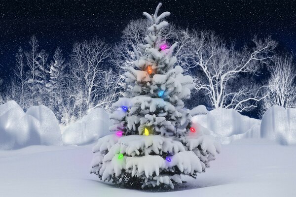 Multicolored garland on a snow-covered fir tree