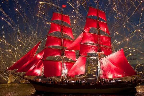 A sailing ship on parade. Fireworks in the night sky