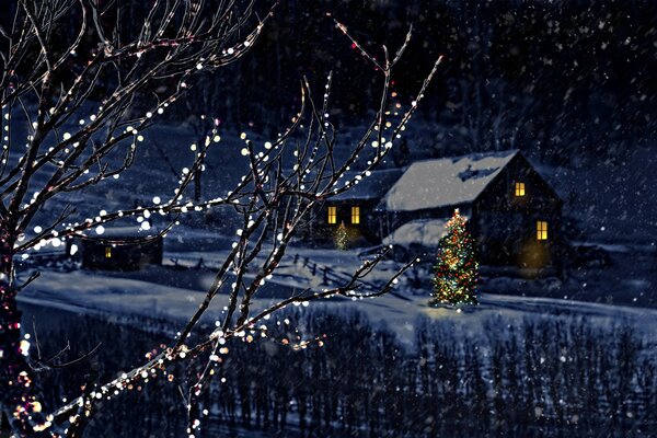 New Year s house on the background of a tree with a garland