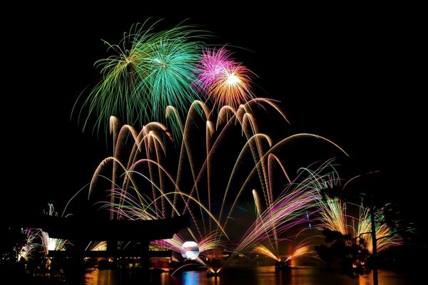 Festive fireworks over the water in the magic kingdom