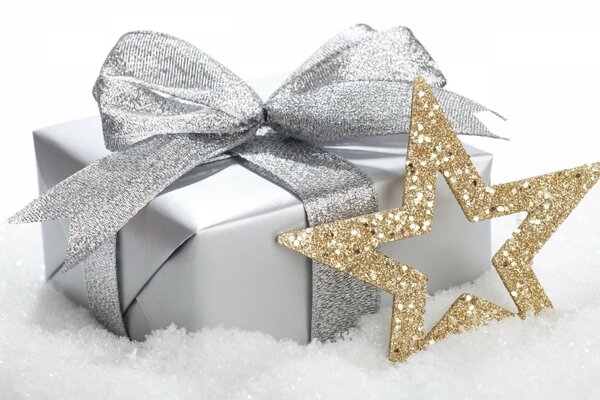 Gift box and gold star on white background