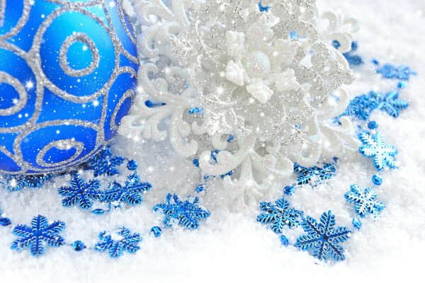 A festive ball in the snow with blue snowflakes