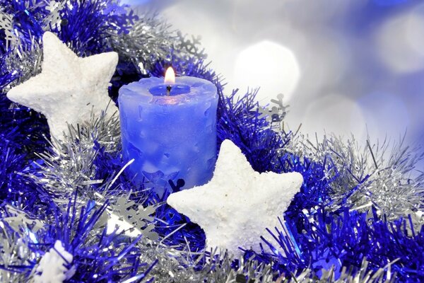 Blue candle on blue tinsel