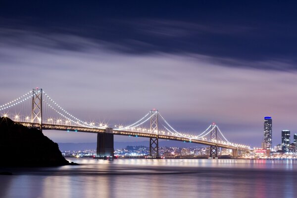 The bridge in San Francisco, located above the river, is a necessary object to shorten the distance