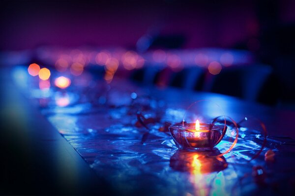 Candle in a candlestick on a dark background