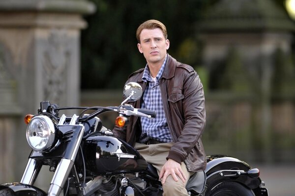 Chris Evans on a black motorcycle