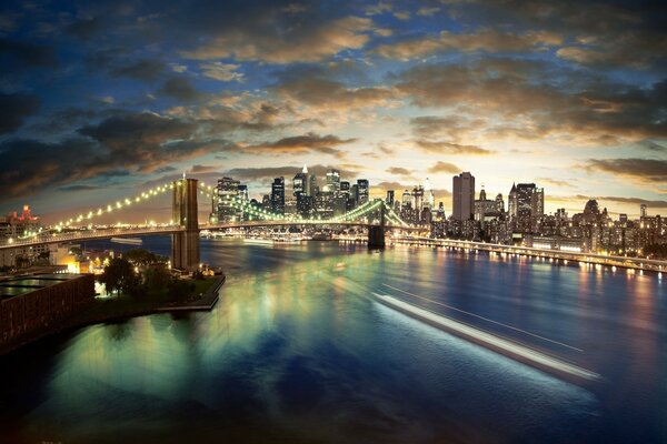 Puente de la ciudad con luces en el fondo de la puesta de sol