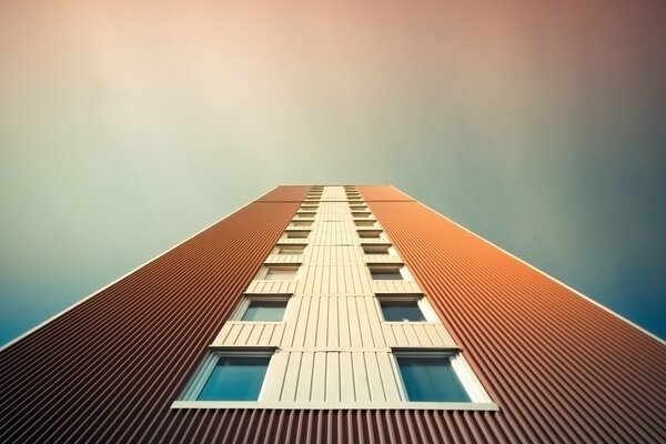 Minimalism. A wall with windows against the sky