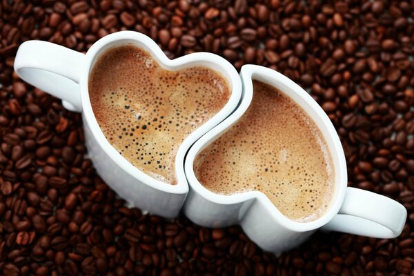 Hot coffee in heart-shaped mugs