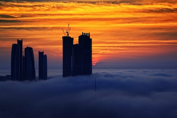 Skyscrapers in the clouds at sunset