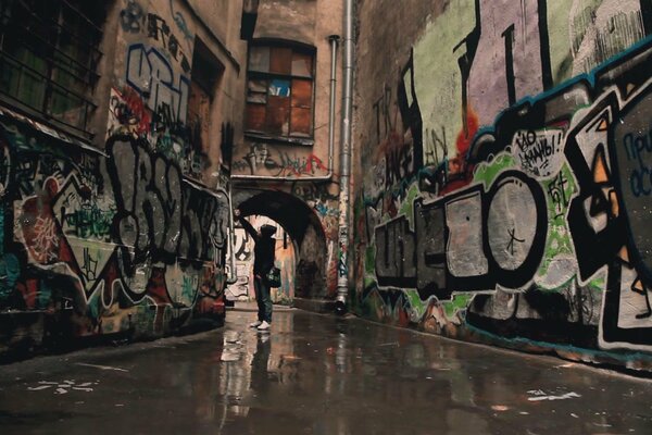 Street artist painting graffiti in the courtyard