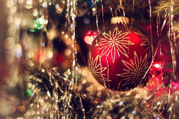 New Year s ball on the Christmas tree in tinsel