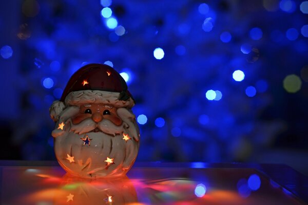 Santa Claus figurine on a festive blue background