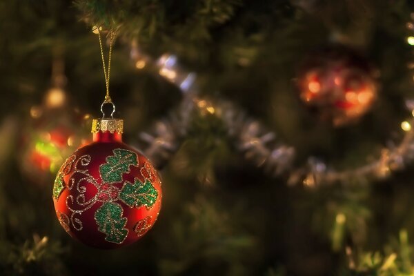 A New Year s ball is hanging on the Christmas tree