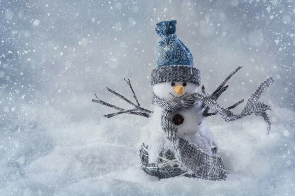 A toy snowman on a background of snow