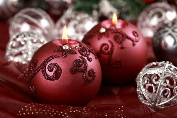 Dark red Christmas candles among silver balls