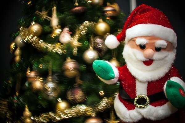 Santa Claus s birthday toy on the background of a decorated Christmas tree