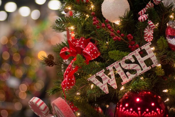Christmas tree decorated with lollipops and an inscription in English: wish