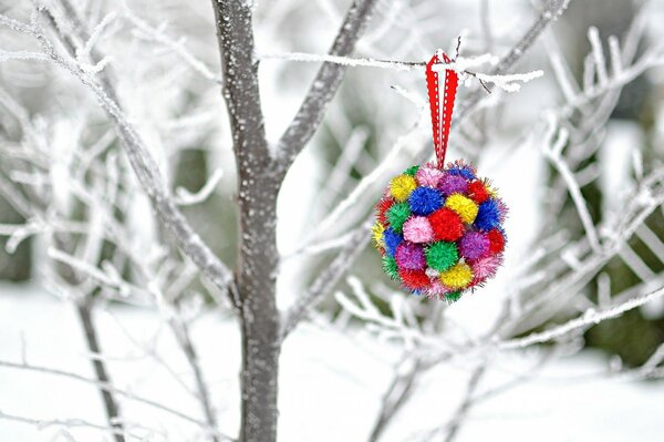 A bright decoration on a snow-covered tree