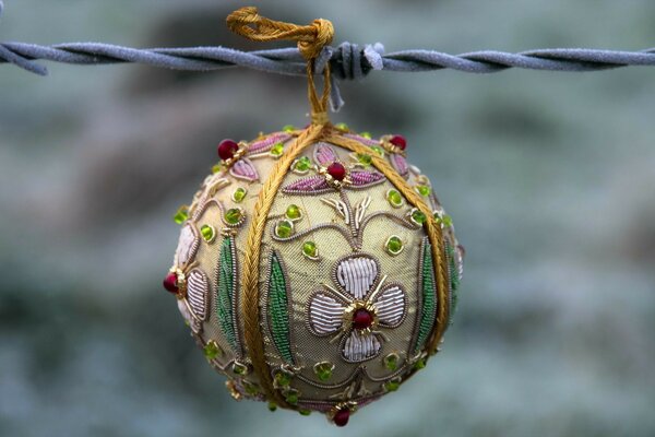 Handmade Christmas tree toy painted with flowers on a blue cord