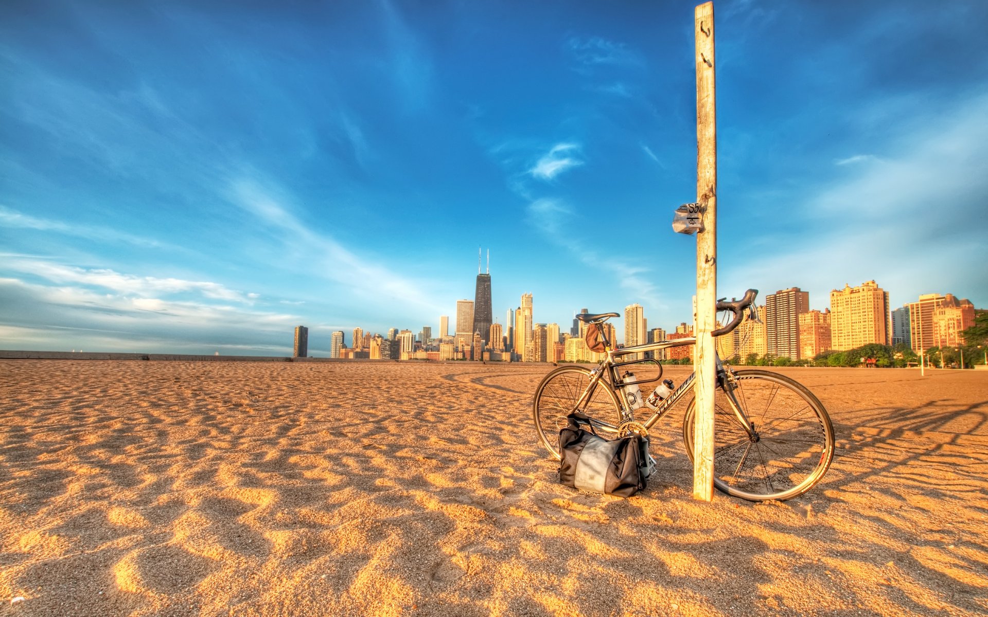 bike beach sand post cities photo