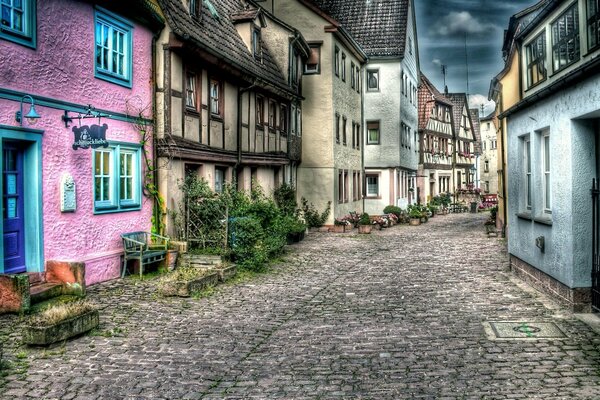 A cozy street with a stone road and colorful houses