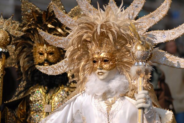 Black and white masks and costumes are worn at a masquerade