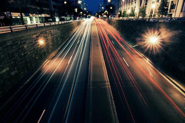 Photo of a night road with a long shutter speed. Professional photo. Photos from the bridge