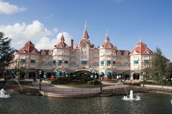 Disneyland castle with fountains against the sky