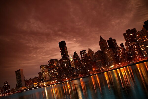Image of a river near New York City, illuminated by city lights