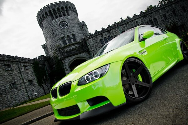 Green BMW on the background of the fortress