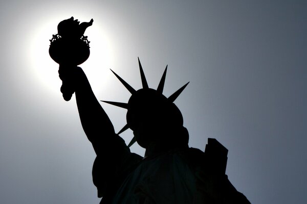 The symbol of New York is the Statue of Liberty against the sky