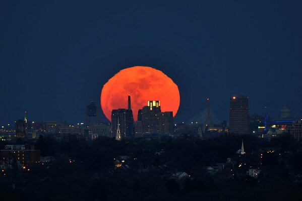 Red moon over Boston at night