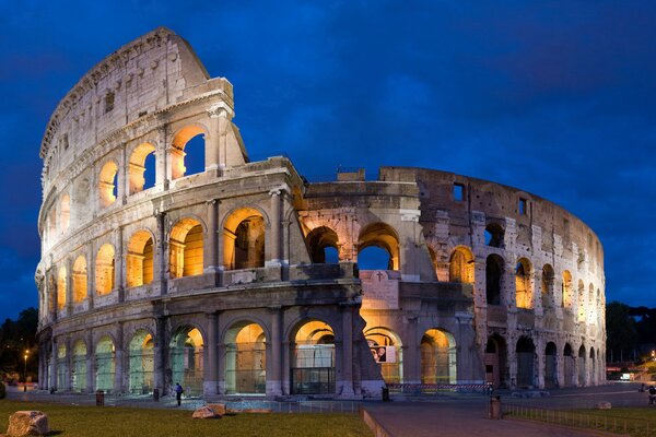 The Roman Colosseum is illuminated from the inside at night