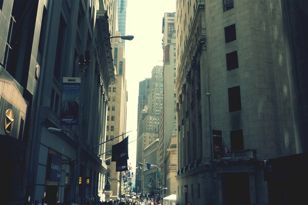 A narrow street between the skyscrapers of New York