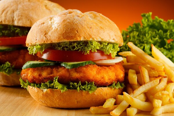 Hamburger with cutlet, lettuce leaves and French fries