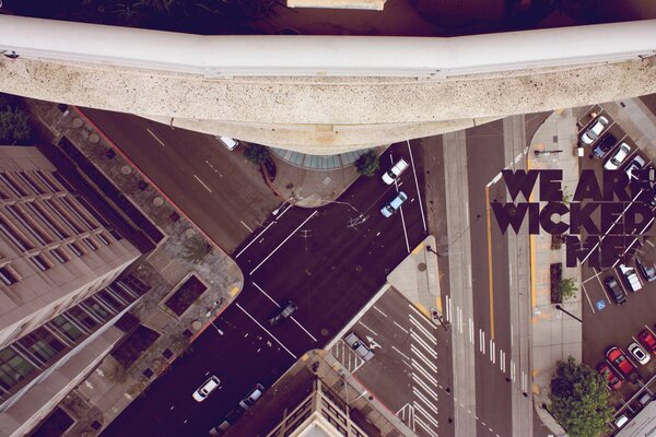 Creative photo of a street from the height of a skyscraper with the inscription