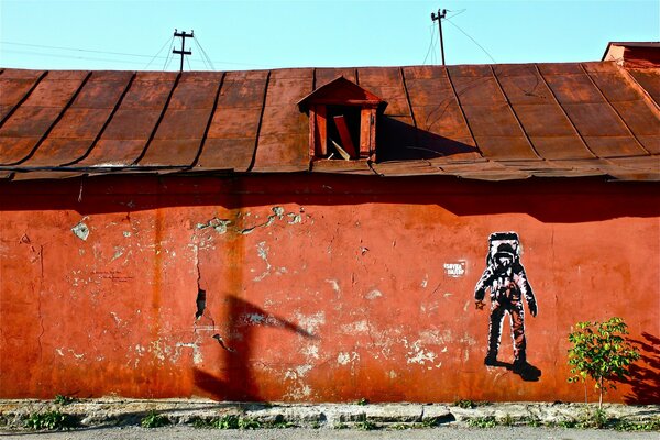 A lonely drawing on an orange wall