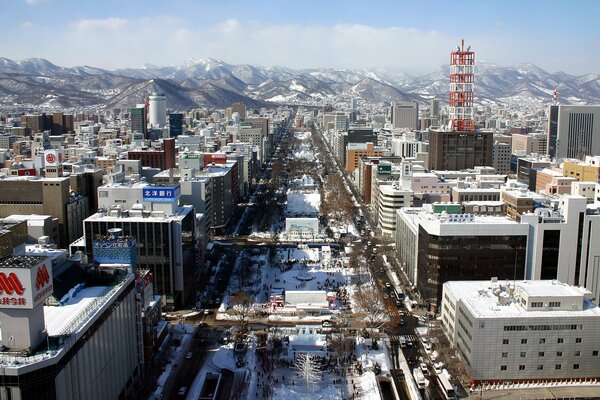 Snow-covered buildings on the background of mountains