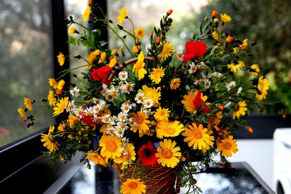 Vase with a bouquet of daisies and poppies