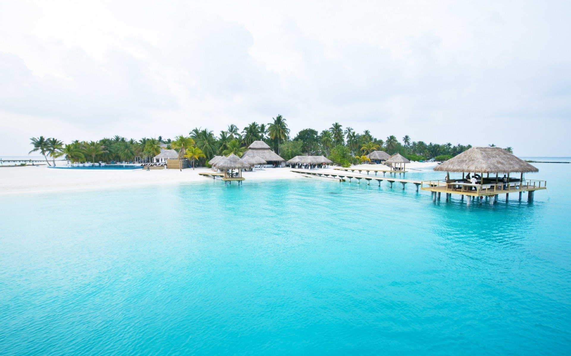 blue pergolas pier palm tropics island sky rain people