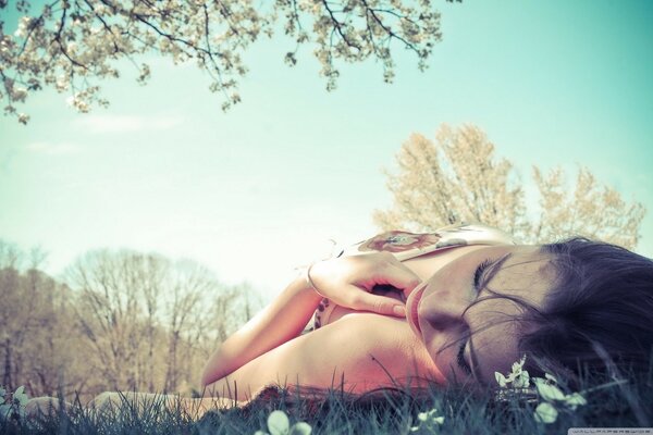 A beautiful girl lies against the sky