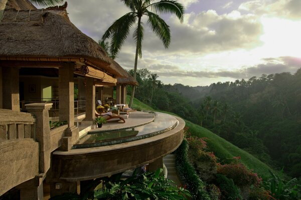 A house in the depths of the tropics, on a cliff