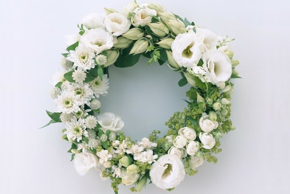 A wreath of white flowers and green leaves