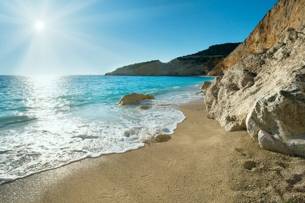 The sultry nature of Greece. Blue sea horizon, sun, sand and rocks